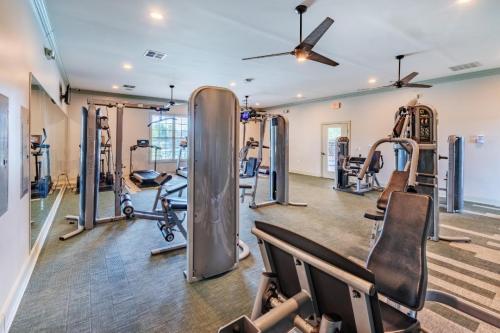 Apartments in Fayetteville, North Carolina A well-lit gym with various exercise machines, including treadmills, weight machines, and benches. Ceiling fans are on, and the walls are light-colored. Parcstone Apartments For Rent in Fayetteville