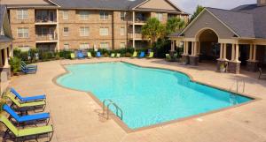 Apartments for rent in Fayetteville, NC - Pool and Patio Area with Lounge Chairs