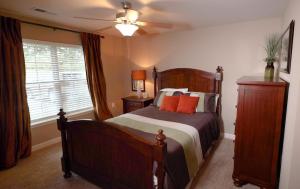 Three Bedroom Apartments in Fayetteville, NC - Model Bedroom with Large Window and Ceiling Fan