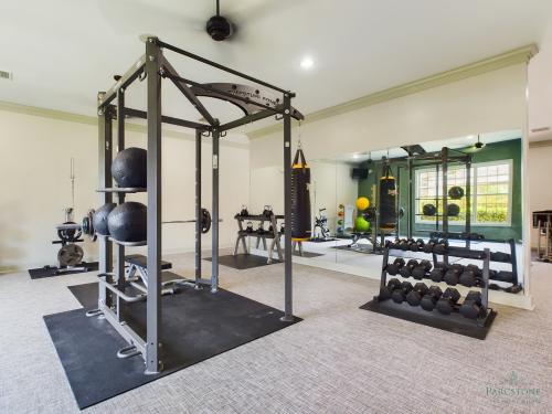 Apartments in Fayetteville, North Carolina A well-equipped home gym with strength training and cardiovascular equipment.